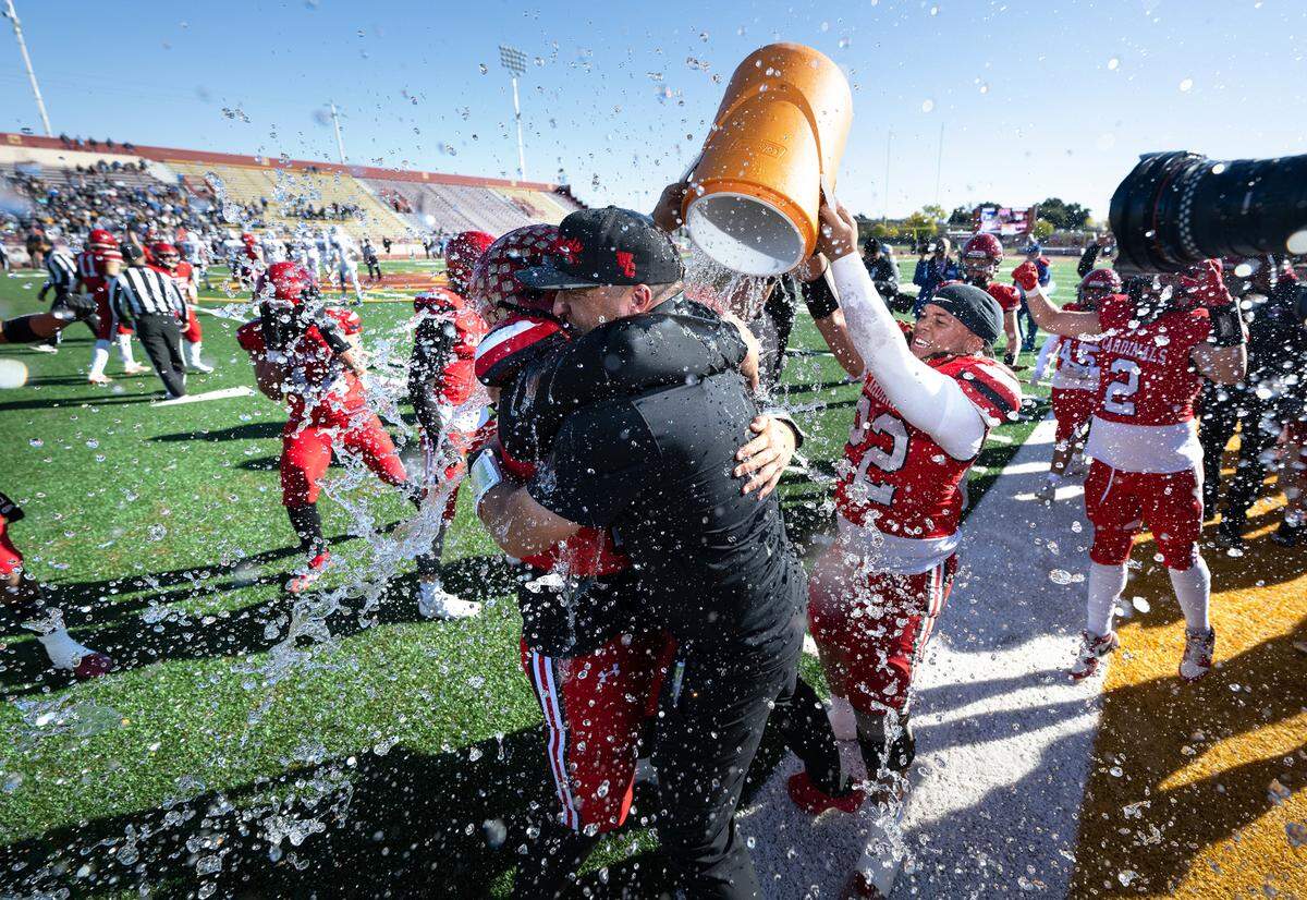 Woodland Christian coach Michael Paschke is doused with cold water after their 36-14 victory over Ripon Christian in the Sac-Joaquin Section Division VII NorCal Qualifier at Sacramento City College in Sacramento, Calif., Saturday, Nov. 25, 2023.