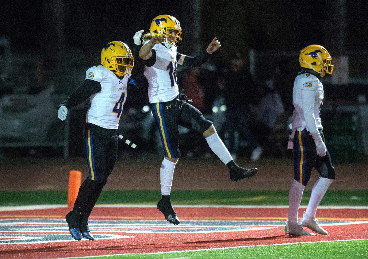Grant’s Semaj Mafu-Hart and Joseph McCray (10) celebrate a touchdown during a Sac-Joaquin Section Division III semifinal with Patterson in Patterson, Calif., Friday, Nov. 18, 2022. Grant won 80-44.