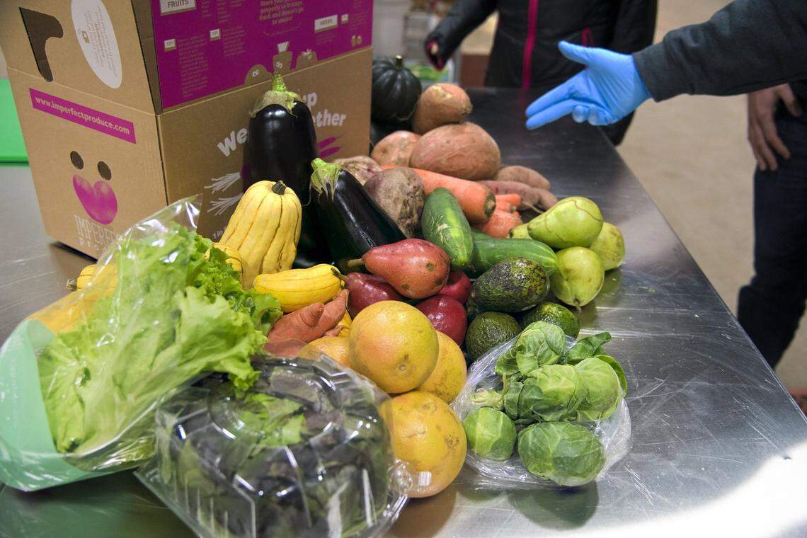 FILE - This Nov. 13, 2018 file photo shows various fruit and vegetables at Imperfect Produce in Severn, Md. The company delivers produce that have been rejected by grocery stores for not fitting cosmetic standards.