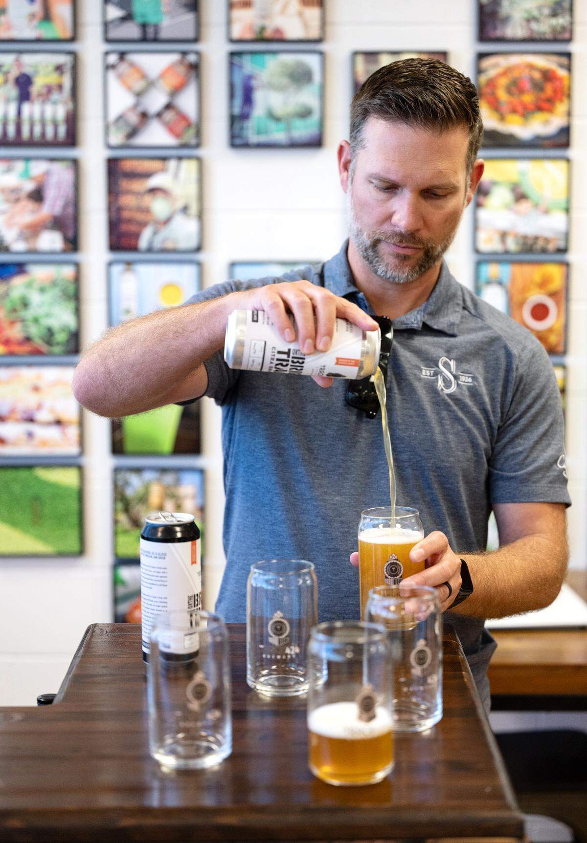 Sciabica Family California Olive Oil CEO Jon Sciabica pours a hazy IPA, Bright Track, in the tasting room at its Yosemite Boulevard headquarters in Modesto, Calif., on Friday, July 22, 2022. The Modesto-based olive oil maker, has started brewing craft beer and plans to sell directly to customers later this year under the name Track 424 Brewery.