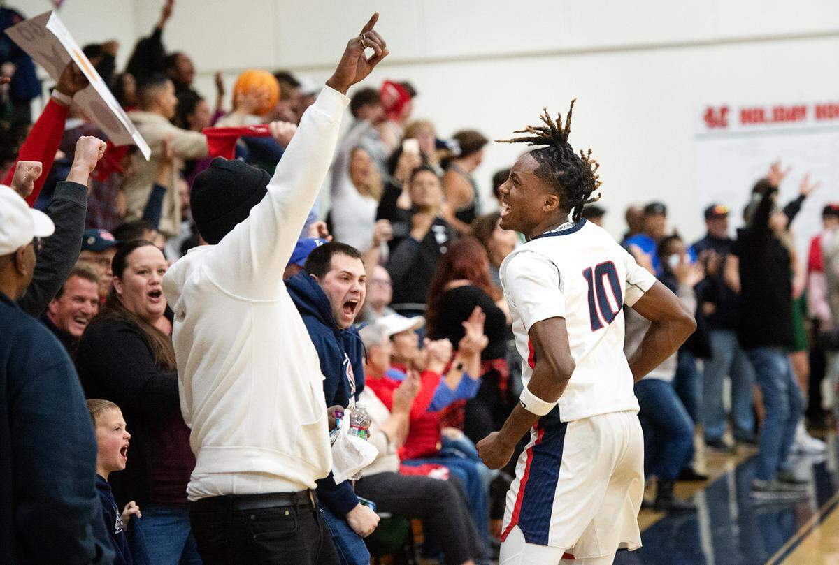 Modesto Christian’s BJ Davis celebrates with the hometown crowd after the Crusaders 57-56 victory over De La Salle in the NorCal Open Division semifinal playoff game in Salida, Calif., Saturday, March 4, 2023.