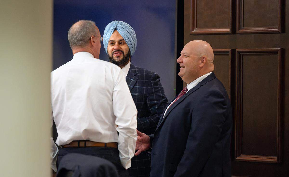 Supervisor Mani Grewal, middle, speaks with Stanislaus County CEO Jody Hayes, right, and supervisor Terry Withrow, left, before a board meeting in Modesto, Calif., Tuesday, June 6, 2023.