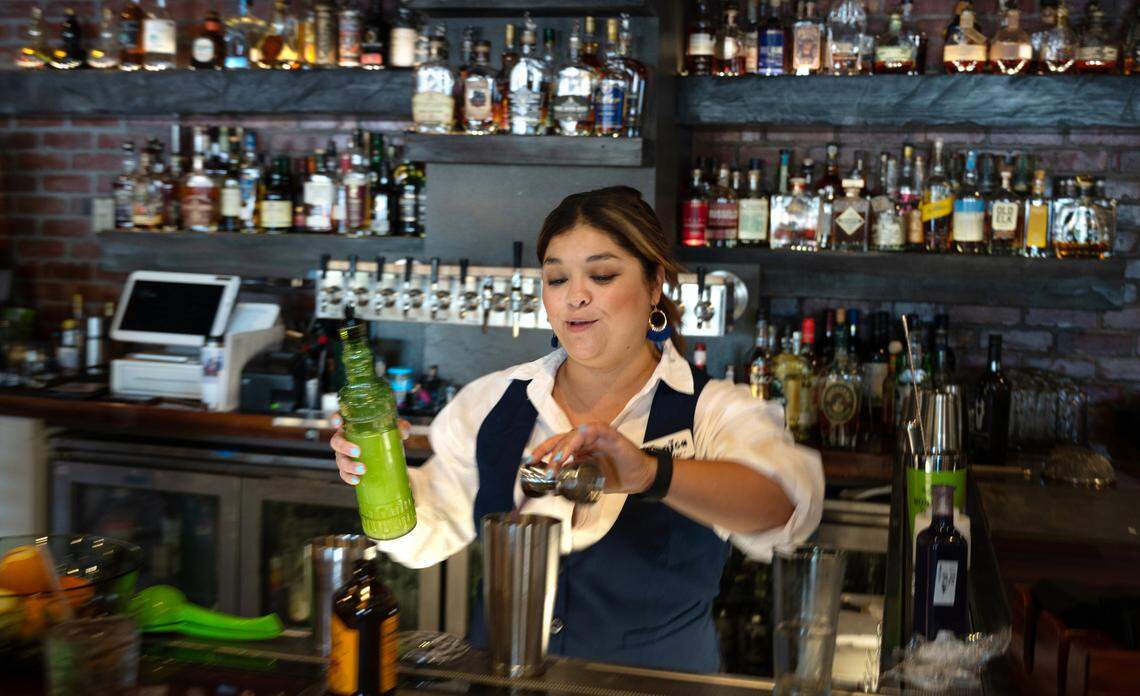 Bartender Monica Reynoso prepares a cocktail at Cora restaurant at Roseburg Square in Modesto, Calif., Friday, May 24, 2024.