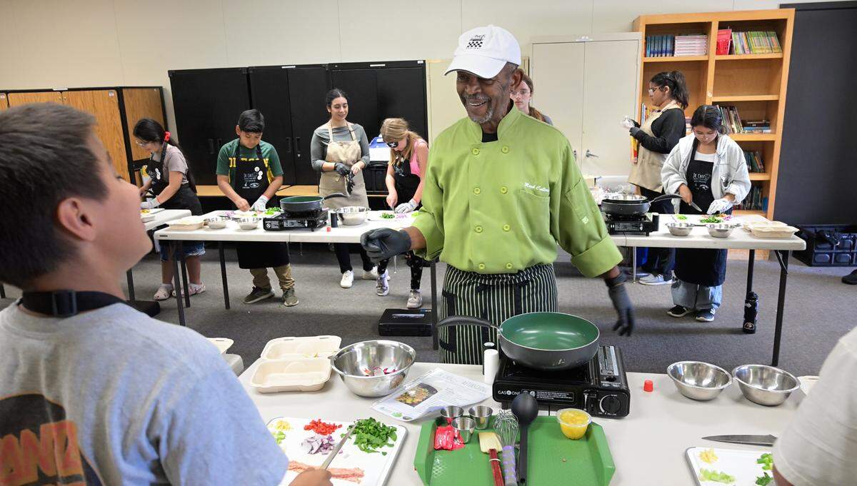 Chef Mark Cullors gives advice to Daniel Rufner during the Junior Chef after school program at Sipherd Elementary School in Modesto, Calif., Thursday, Sept. 19, 2024.