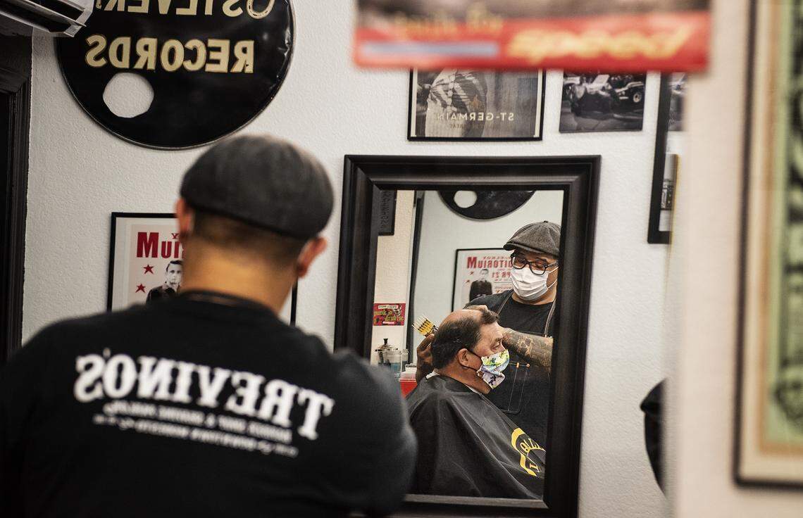Tony Trevino gives Doug Maner a haircut at Trevino’s Barbershop in Modesto, Calif., on Thursday, May 28, 2020.