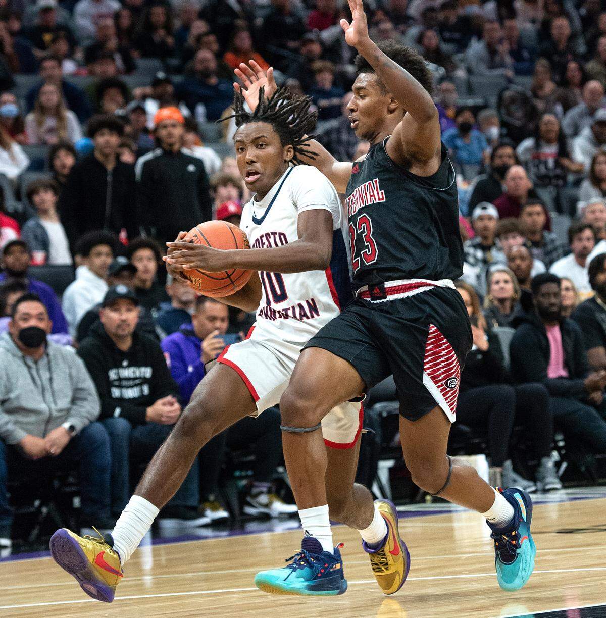 Modesto Christian’s BJ Davis charges the basket as Centennial’s Ramsey Huff defends during the boys Open Division CIF State Basketball Championship game with Centennial at Golden 1 Center in Sacramento, Calif., on Saturday, March 12, 2022. Centennial won the game 59-50.