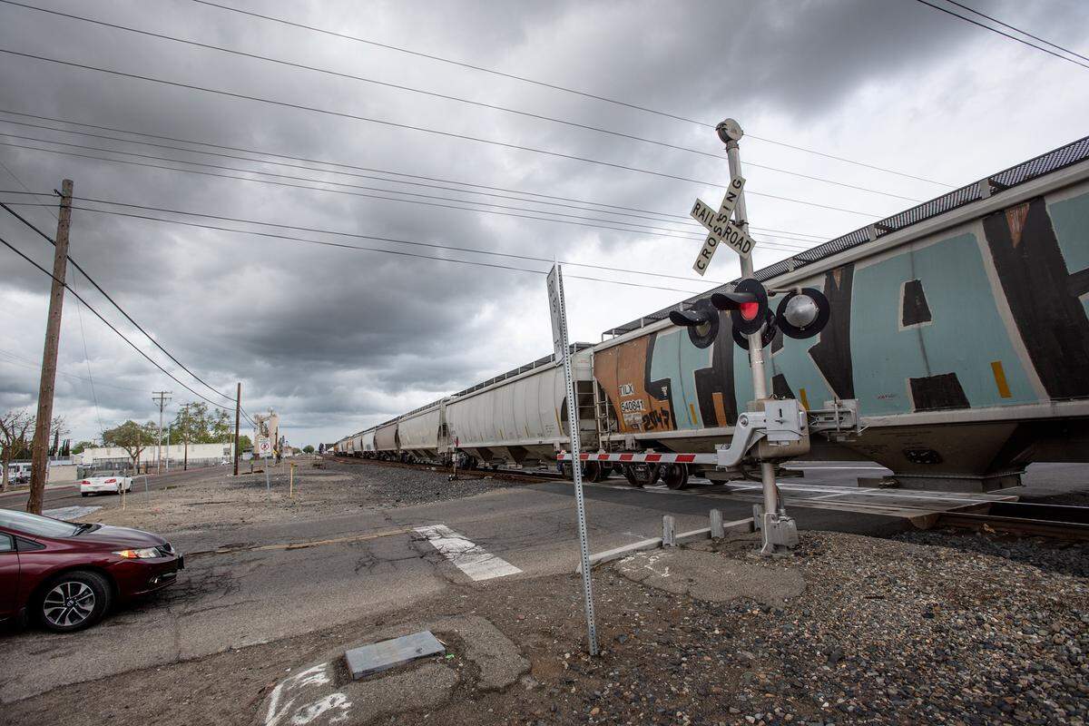A freight train passes through downtown Turlock at F Street in Turlock, Calif., on Monday, March 28, 2022.