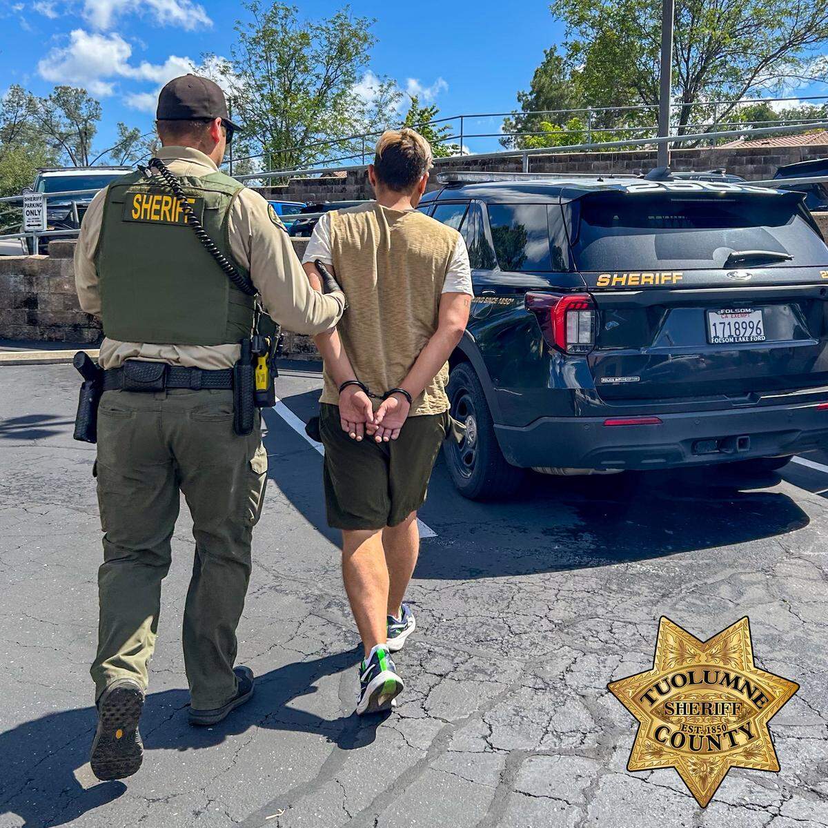 A Tuolumne County sheriff’s deputy escorts Christopher Joseph Torres, 32, of Sonora, following his arrest April 28, 2026, in connection with a child sexual abuse material investigation.