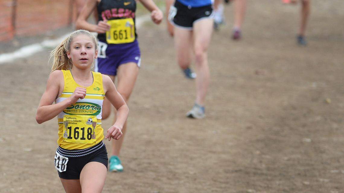 Brianna Personius of Sonora heads down the slope toward the three-mile mark during the girls D-IV race in the California state cross country championships at Woodward Park in Fresno on Saturday, Nov. 30, 2019.