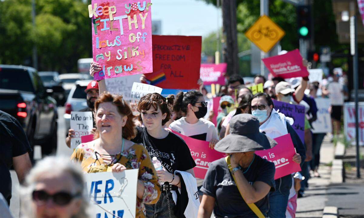 Participants march down McHenry Avenue as hundreds rally for abortion rights in Modesto, Calif., on Saturday, May 14, 2022.