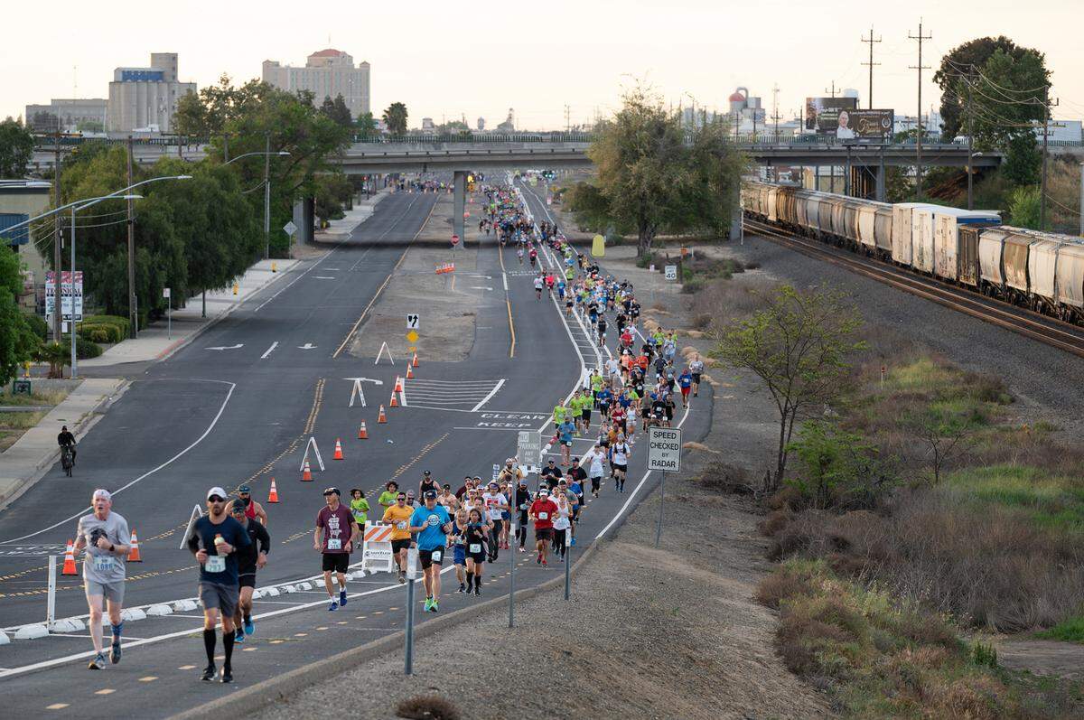Runners make their way up 9th Street during the Modesto Marathon in Modesto, Calif., on Sunday, March 27, 2022.