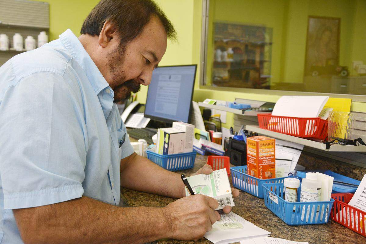 The new Familia Farmacia, a locally owned independent pharmacy, opened on Crows Landing Road in Modesto, Calif. Pharmacist Isaac Montelongo prepares a prescription on Sept. 20, 2019.