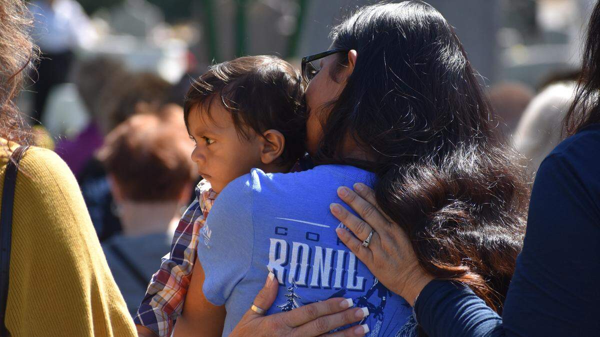 Newman police Cpl. Ronil Singh’s widow, Anamika, holds their son at the 2019 Stanislaus County Peace Officers Memorial service on Wednesday, May 1, at Lakewood Memorial Park in Hughson, CA.