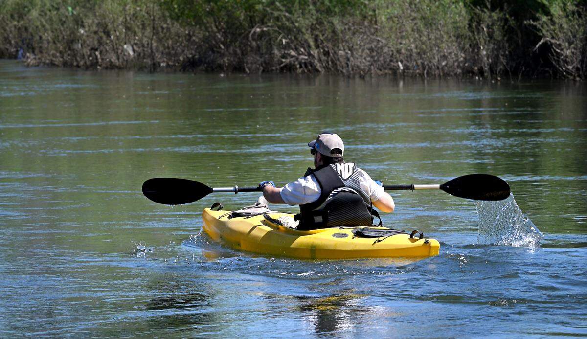 A kayaker paddles on the Tuolumne River in the Tuolumne River Regional Park in Modesto, Calif., Friday, May 10, 2024.