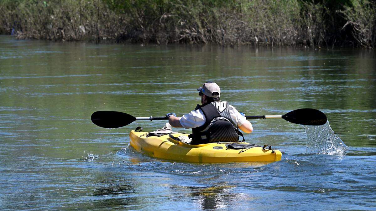 A kayaker paddles on the Tuolumne River in the Tuolumne River Regional Park in Modesto, Calif., Friday, May 10, 2024.