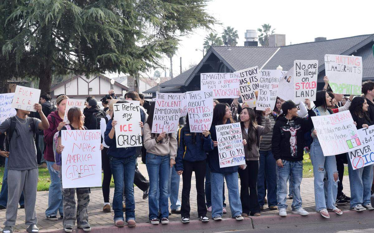 At Central Park in Turlock, students hold up signs in protest of Immigration and Customs Enforcement agents Friday, Jan. 30, 2026.