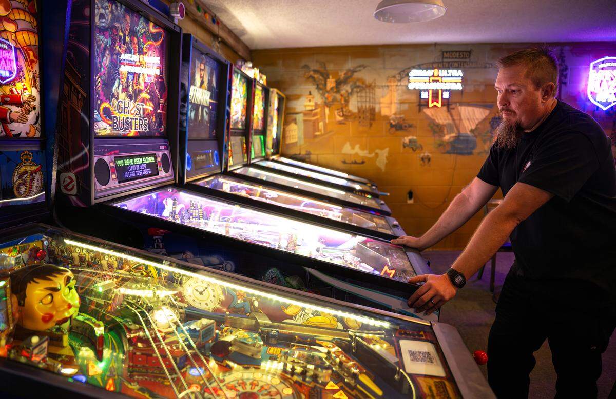Fast Eddie’s MOAB owner Robert Wilson plays a round of pinball on the Ghostbusters game at MOAB in Modesto, Wednesday, Sept. 24, 2025. 