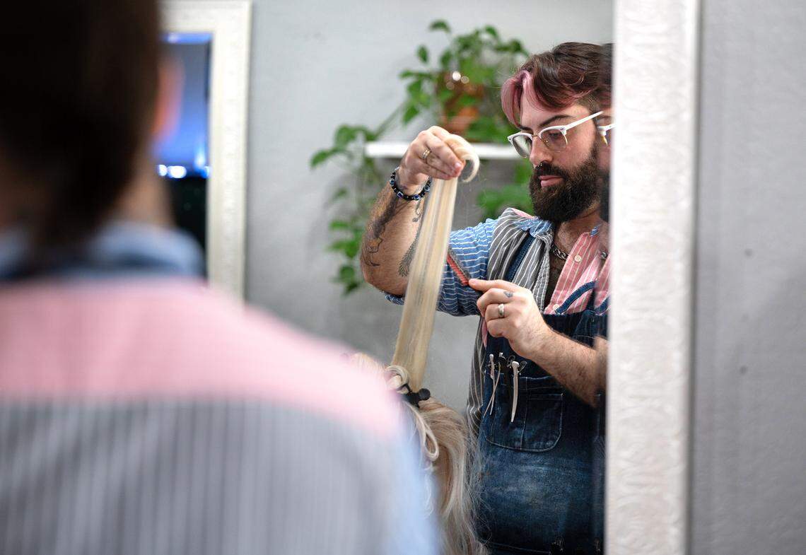 Larry Soria styles a wig at the David Allen Salon in Oakdale, Calif., Tuesday, Aug. 20, 2024.