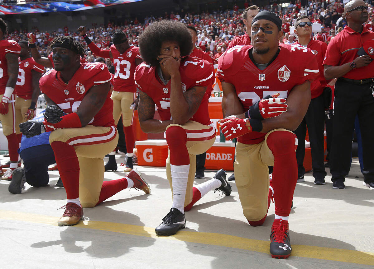Eli Harold) Colin Kaepernick and Eric Reid of the San Francisco 49ers kneel during the national anthem before a game against the Dallas Cowboys on Oct. 2, 2016, at Levi's Stadium, in Santa Clara. 
