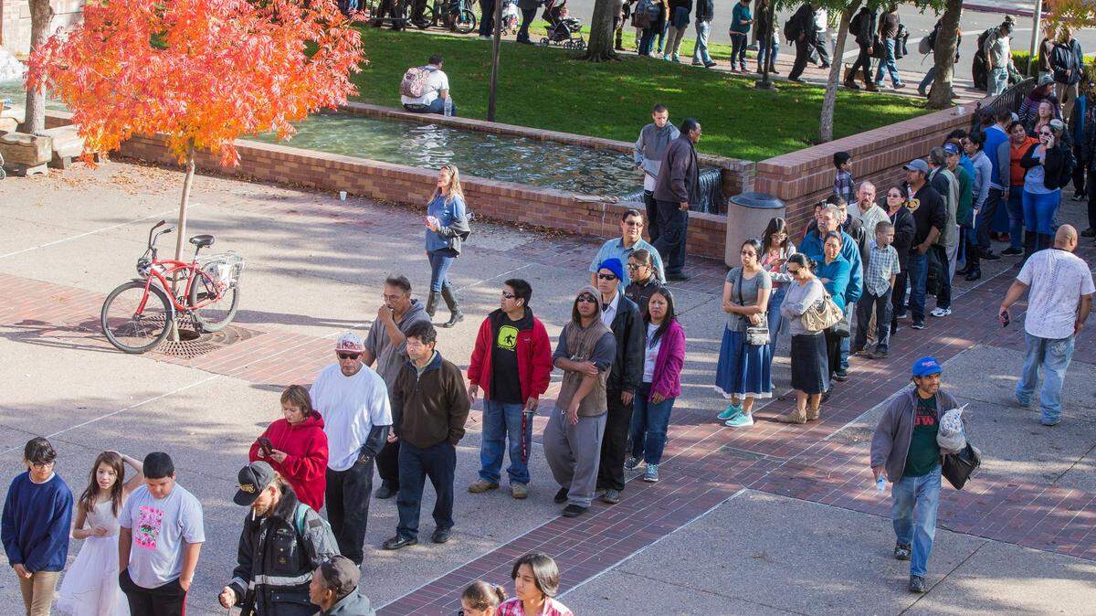 People line up outside Modesto Centre Plaza to enjoy a Thanksgiving Day dinner provided by Dan Costa and a team of volunteers Thursday afternoon. 