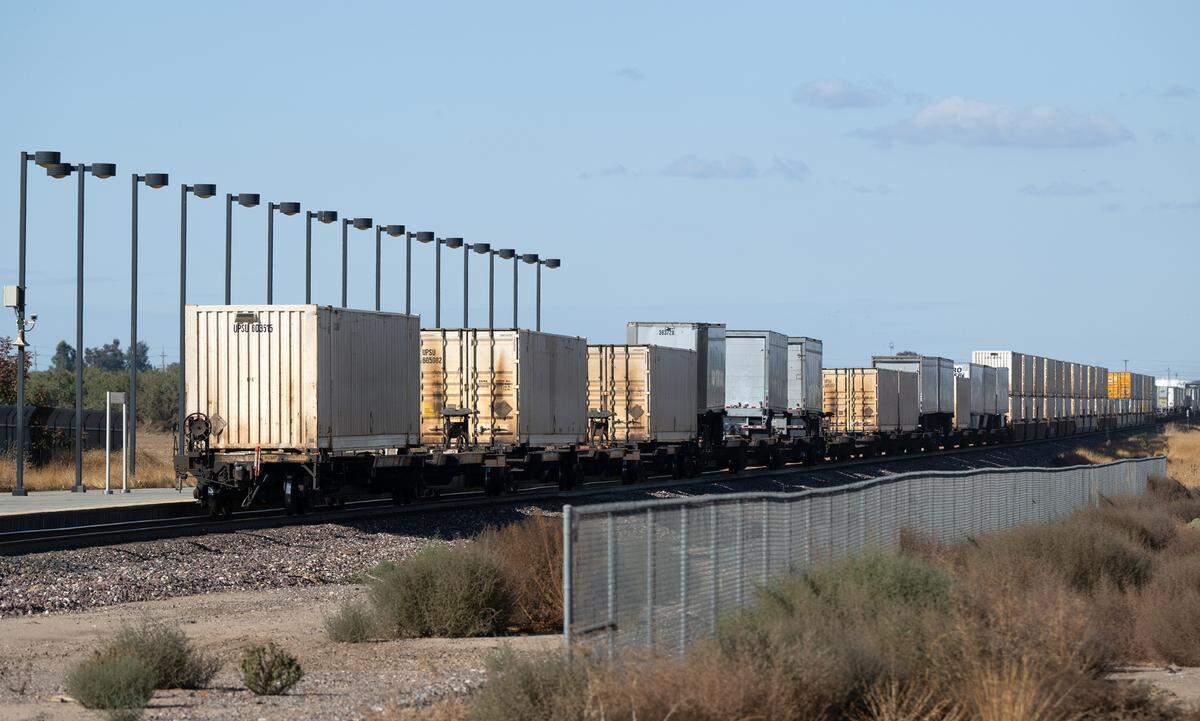 A freight train passes the Amtrak Station in Modesto on Thursday, Oct. 31, 2024.
