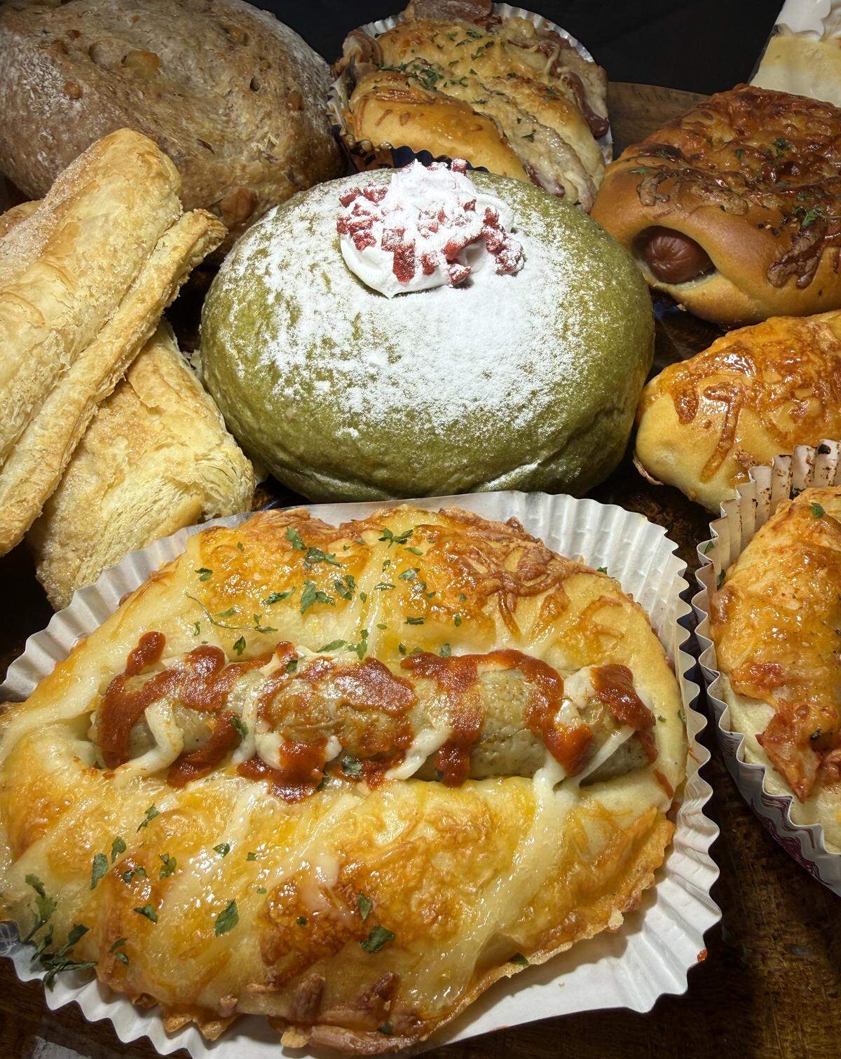 A spicy sausage pastry and strawberry matcha bun from 85°C Bakery in Stockton, CA.
