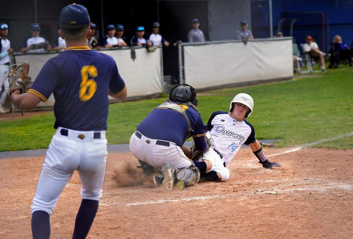 Gregori catcher Christian Razo tags out Downey’s Owen Sacuskie in a CCAL game against Downey High at Downey High School in Modesto, Calif. on Wednesday, April 16, 2025.