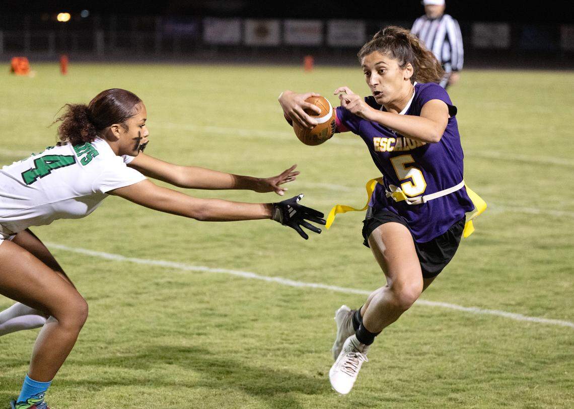 Escalon’s Sammy Lang runs the ball as St. Mary’s Larissa Hackley defends duirng the CIF Sac-Joaquin Section Division II semifinal playoff game in Escalon, Calif., Wednesday, Nov. 1, 2023. St. Mary’s won the game 12-6.