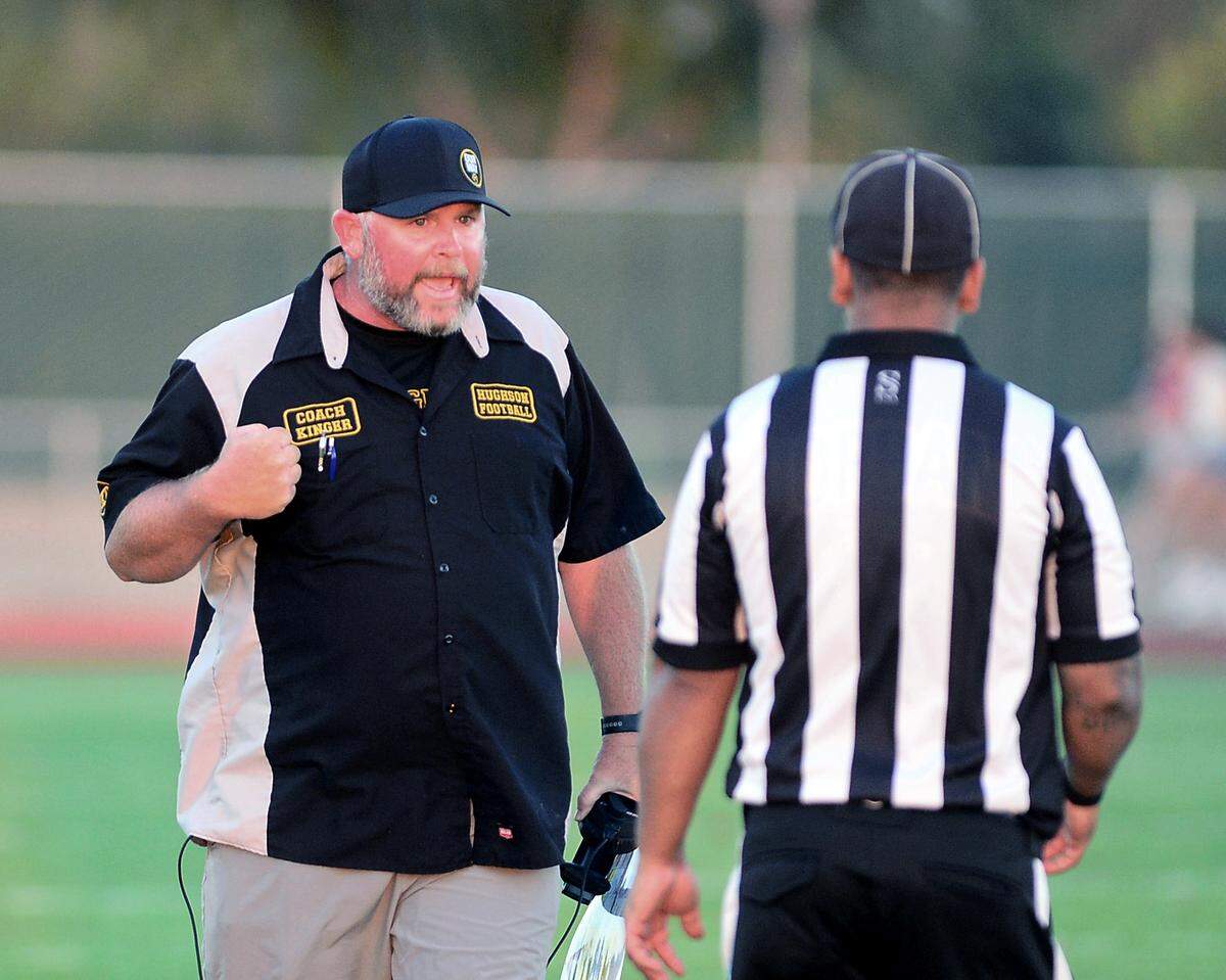 Hughson Head Coach Shaun King contests a call with a referee during a game between Hughson High School and Central Valley High School at Hughson High School in Hughson California on August 25, 2023.