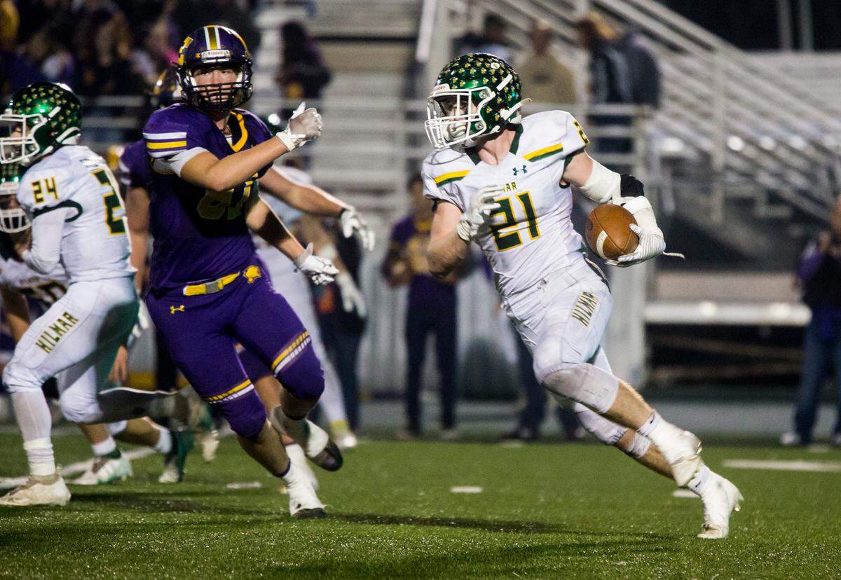 Blake Westmoreland, 21, of Hilmar High round the defense of Escalon High on his way up field. Escalon High School took on Hilmar High football during the 2021 CIF Sac-Joaquin Football Playoffs - Division V at Saint Mary’s High School in Stockton, Ca. Escalon came out on top as the champions with a 20-13 win over Hilmar.