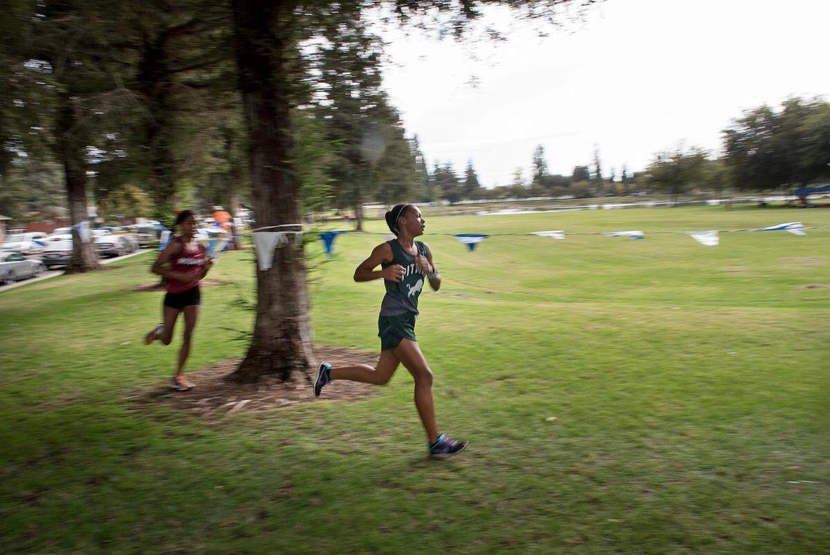 Pitman runner Camila Stephens, right, finished in fifth place with a time of 19:05.81 during the CCAL meet at Donnelly Park in Turlock, Calif., on Wednesday, Oct. 3, 2018.