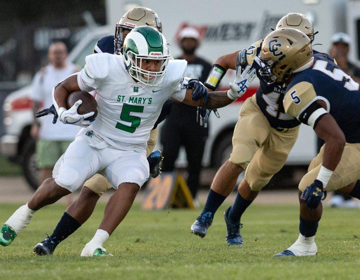 St. Mary’s Naseri Danielson, left, runs the ball as Central Catholic’s Jaelen Nichols (5) closes the gap during the non-league game at Central Catholic High School in Modesto, Calif., on Friday, September 2, 2022. St. Mary’s won the game 47-7.