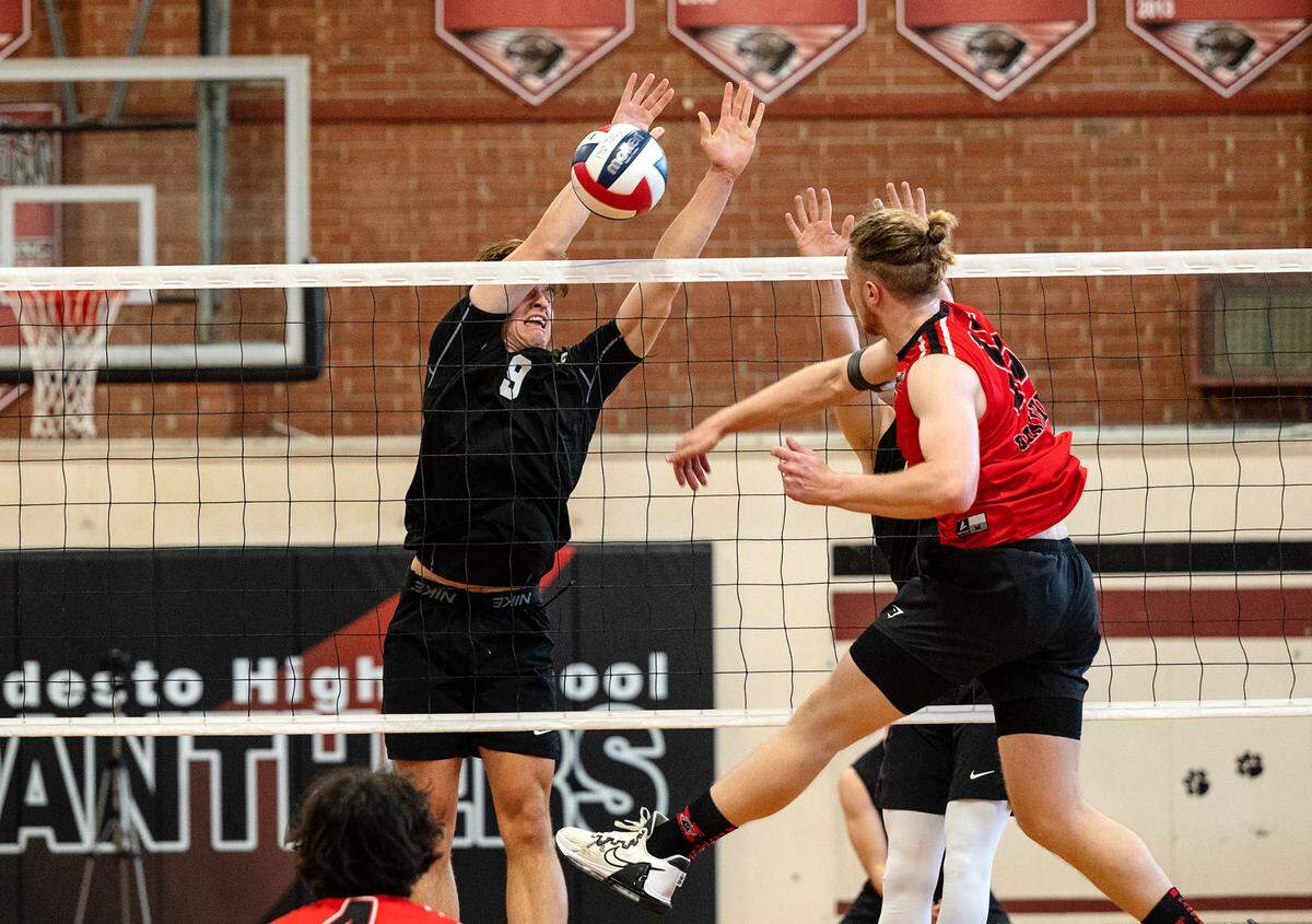 Pitman’s Seth Vink blocks the shot of Modesto’s Cole Rogers during the Central California Athletic League match in Modesto, Calif., Thursday, April 27, 2023. Modesto won the match 3-2.