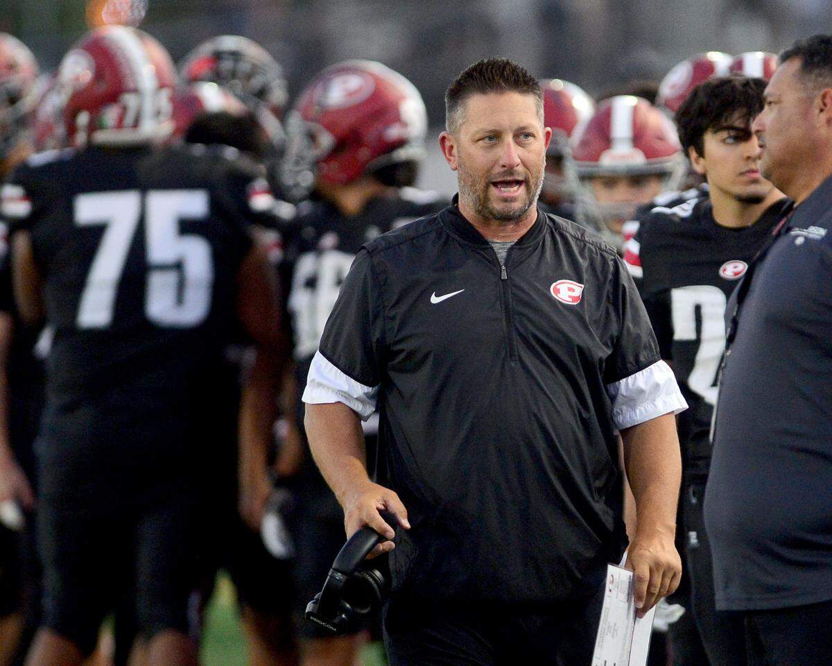 Patterson Head Coach Rob Cozart walks the sideline during a game between Central Catholic High School and Patterson High School at Patterson High School in Patterson California on September 9, 2024. Central Catholic won the game 25-14