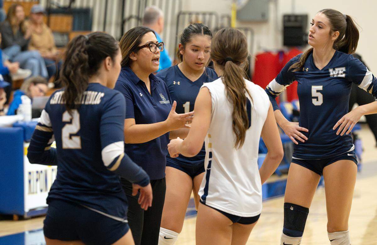Central Catholic coach Michelle Springmeyer, left, talks with her players on a time out in the Sac-Joaquin Section Division III quarterfinal playoff match with Ripon Christian at Ripon Christian High School in Ripon, Thursday, Oct. 31, 2024.