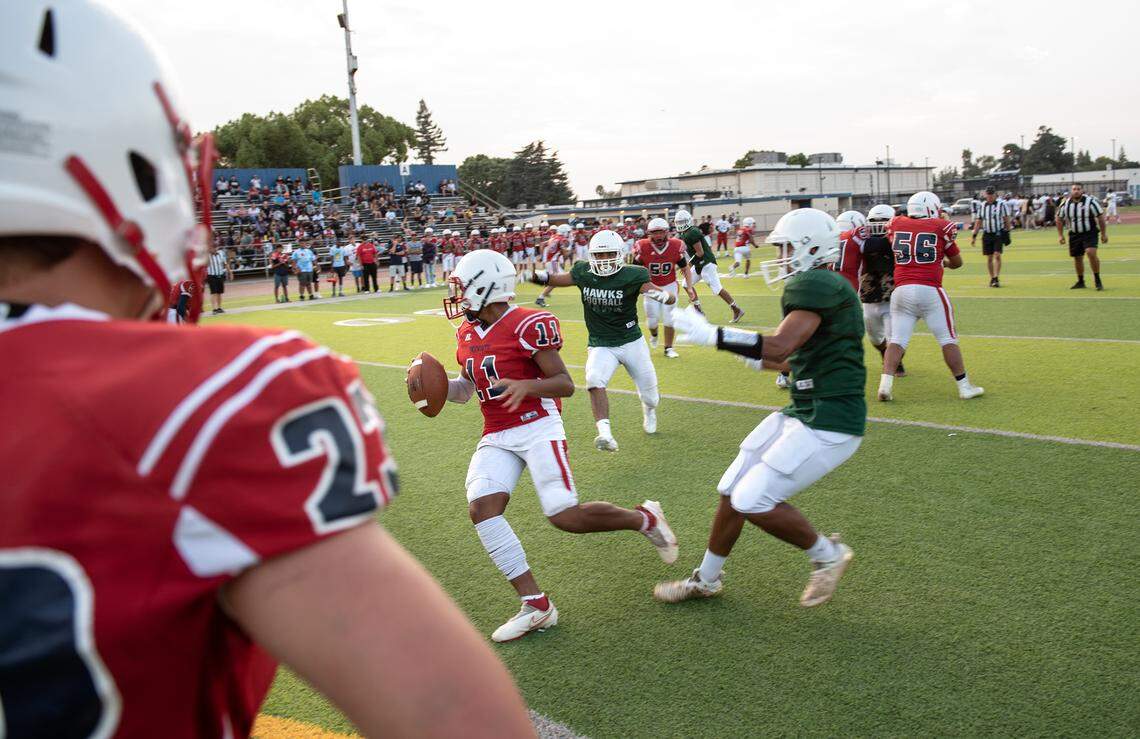 Beyer quarterback evades Central Valley rushers during a pre-season scrimmage at Downey High School in Modesto, Calif., on Friday, Aug. 13, 2021.