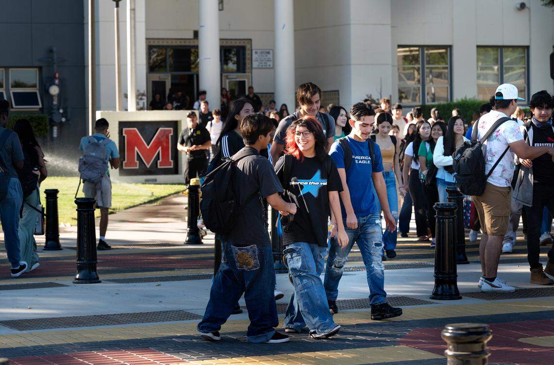 Students cross Paradise Road outside Modesto High School in Modesto, Calif., Tuesday, Aug. 20, 2024. The city recently reduced vehicle traffic to two lanes added bicycle lanes and improved the crosswalks around the school.