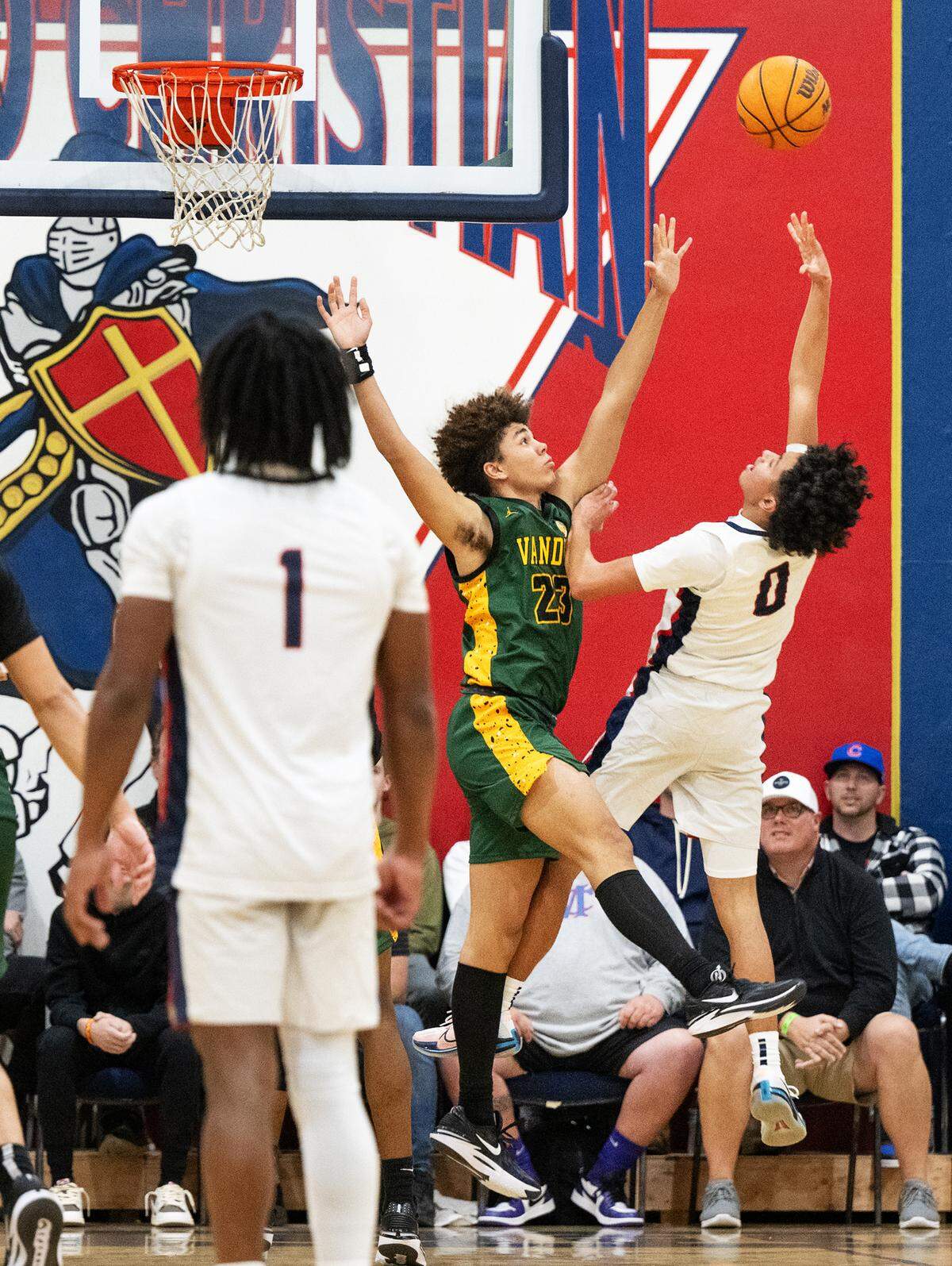 Modesto Christian’s Myles Jones scores over Vanden’s Isiah Dixon during the Holiday Hoop Classic championship game at Modesto Christian High School in Salida, Calif., Saturday, Dec. 30, 2023.
