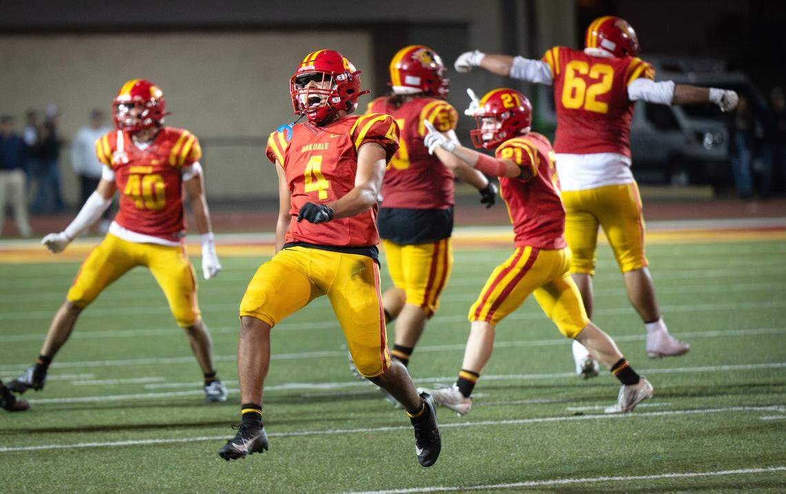 Oakdale’s Gavin Wyatt (4) and teammates celebrate a fourth down stop during the Valley Oak League game with Central Catholic in Oakdale, Friday, Oct. 17, 2025.