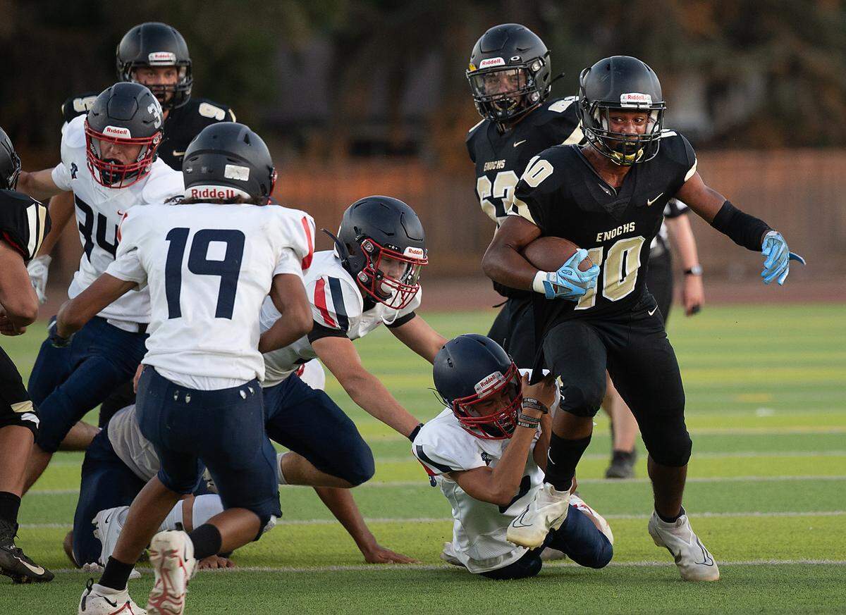 Enochs’ Aiden Muhammad runs the ball during Friday’s game with Beyer at Downey High School in Modesto, Calif., on August 19, 2022. Enochs won the game 35-6.