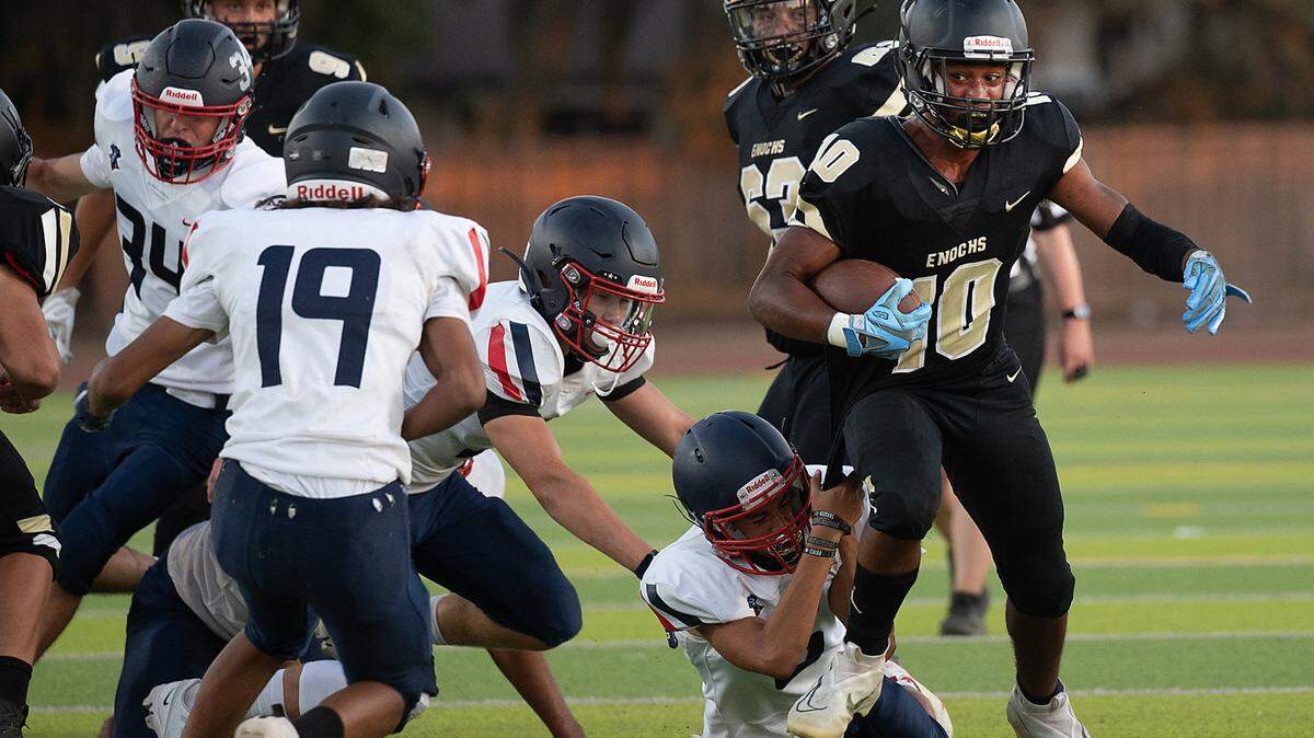 Enochs’ Aiden Muhammad runs the ball during Friday’s game with Beyer at Downey High School in Modesto, Calif., on August 19, 2022. Enochs won the game 35-6.