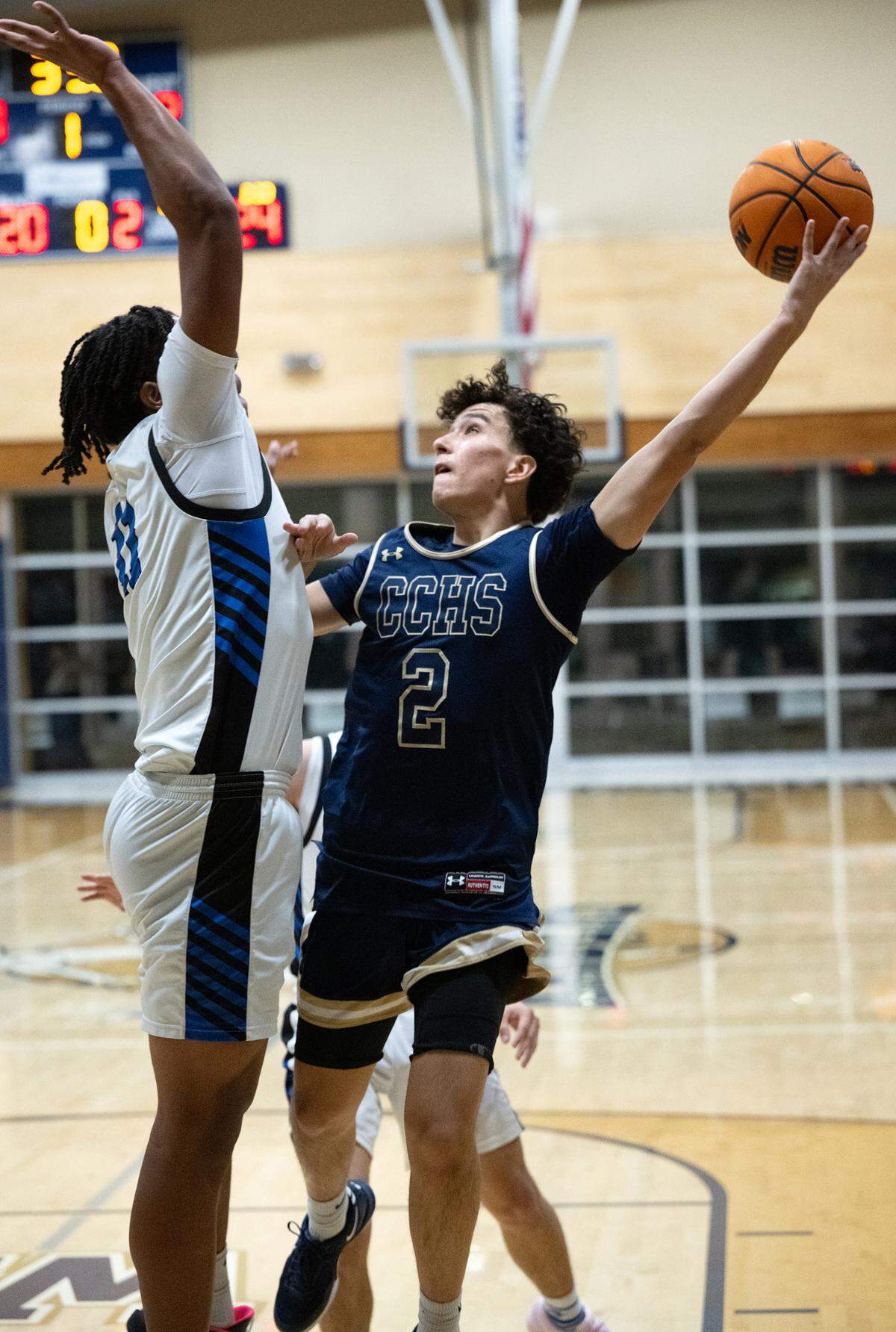 Central Catholic’s Jordan Magana scores over Atwater’s Sylas Austin during the Mark Gallo Invitational basketball tournament game at Central Catholic High School in Modesto, Friday, Dec. 13, 2024.