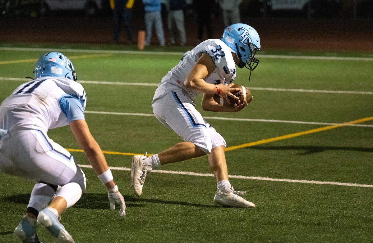 Downey’s Francisco Diaz recovers a Turlock fumble during the Central California Athletic League game at Turlock High School in Turlock, Friday, Oct. 18, 2024.