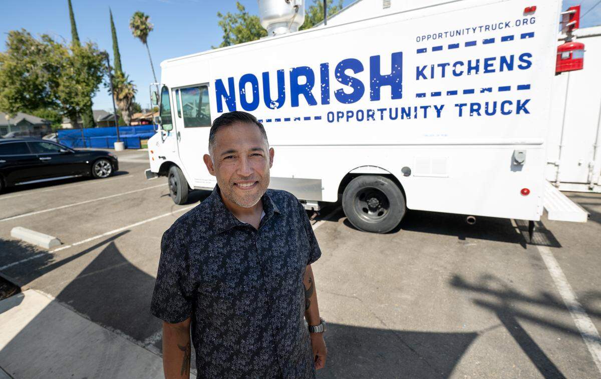 Turlock Gospel Mission director Christian Curby outside with the Nourish Kitchen food truck in Turlock, Wednesday, Aug. 13, 2025.