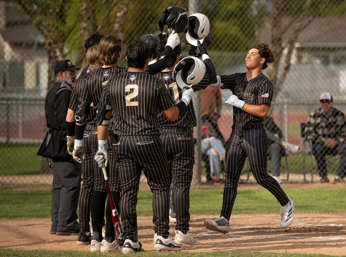 Hughson’s Lawson Aviles, right, crosses home plate after launching a grand slam homerun during a Trans-Valley League game with Orestimba in Hughson, Calif., Friday, March 28, 2025.