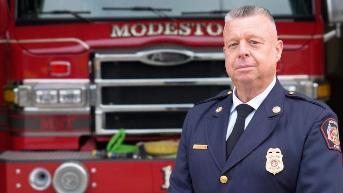 Newly appointed Modesto Fire Chief Shanon Evans poses in front of a department engine.