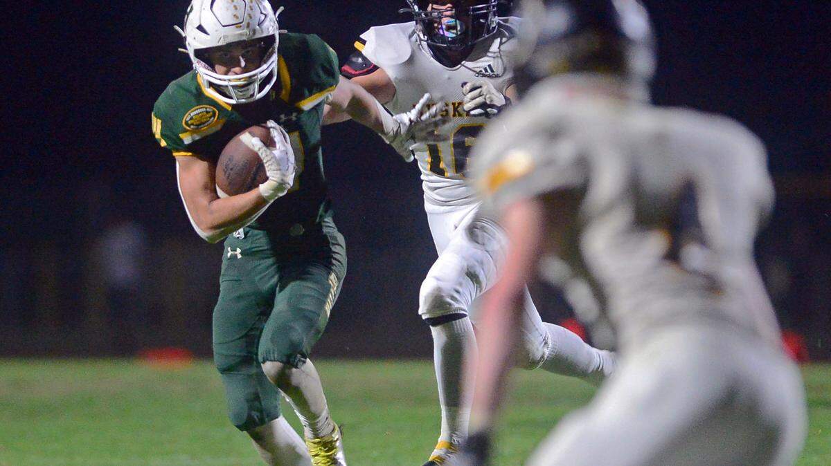Hilmar running back Luis Vargas (14) eyes a Hughson defender during a game between Hughson High School and Hilmar High School at Hughson High School in Hughson CA on October 14, 2022.