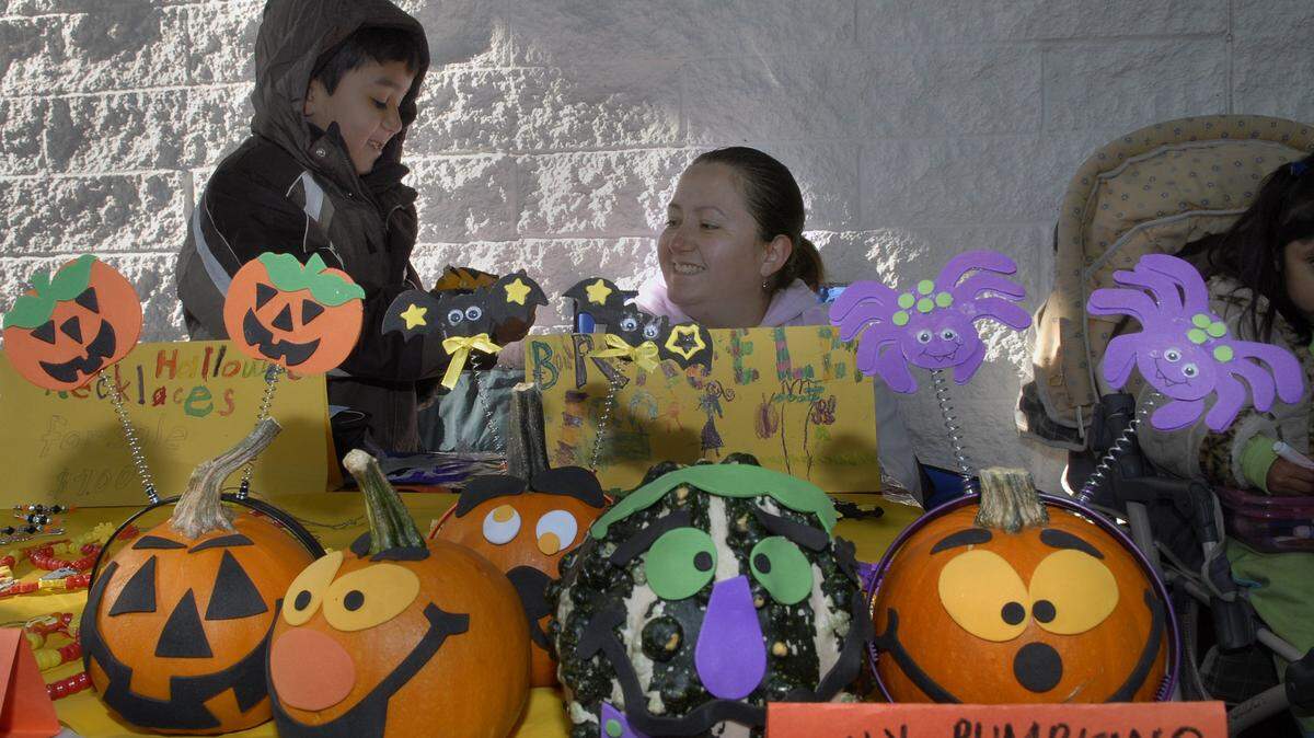 In October 2008, Diego Gomez, 8, and his mom, Sonia Gomez, both of Modesto, sell “silly pumpkins,” necklaces, and bracelets with a Halloween theme at the Modesto Library All-Kids Craft Fair.