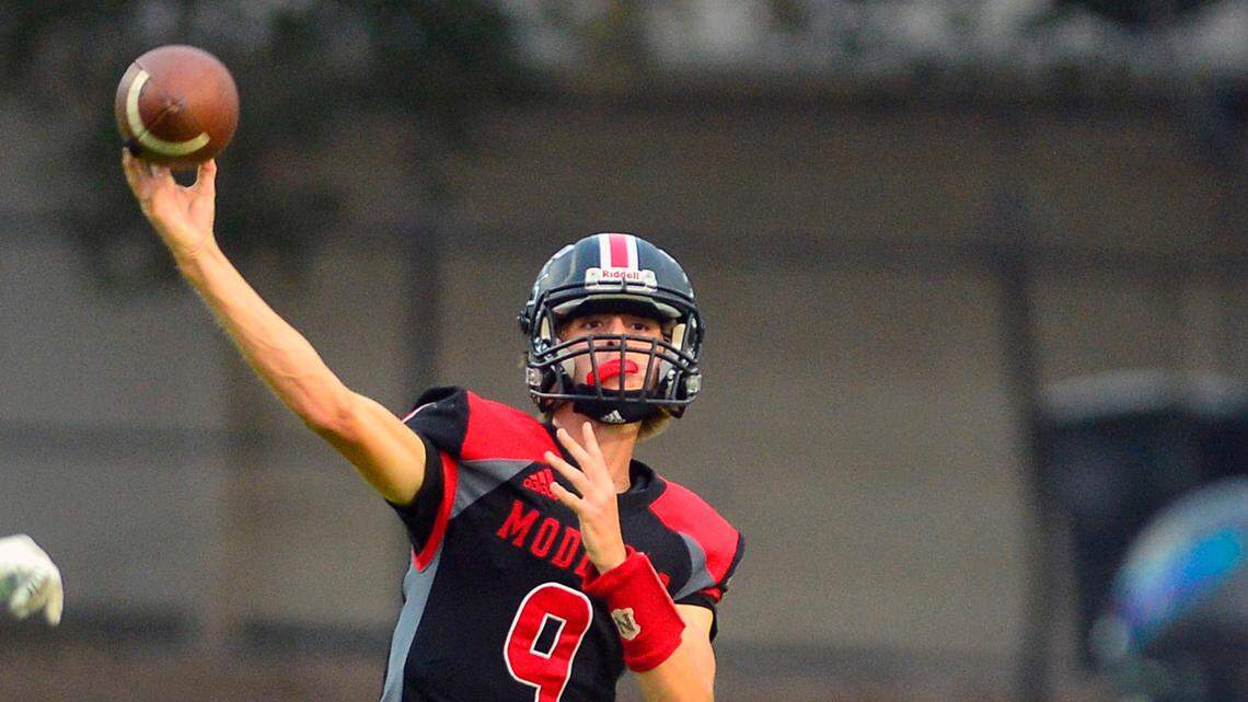 Modesto High quarterback Eli McCabe throws the ball deep down the field during a football game between Modesto High School and Johansen High School at Downey High School in Modesto California on August 20, 2021.