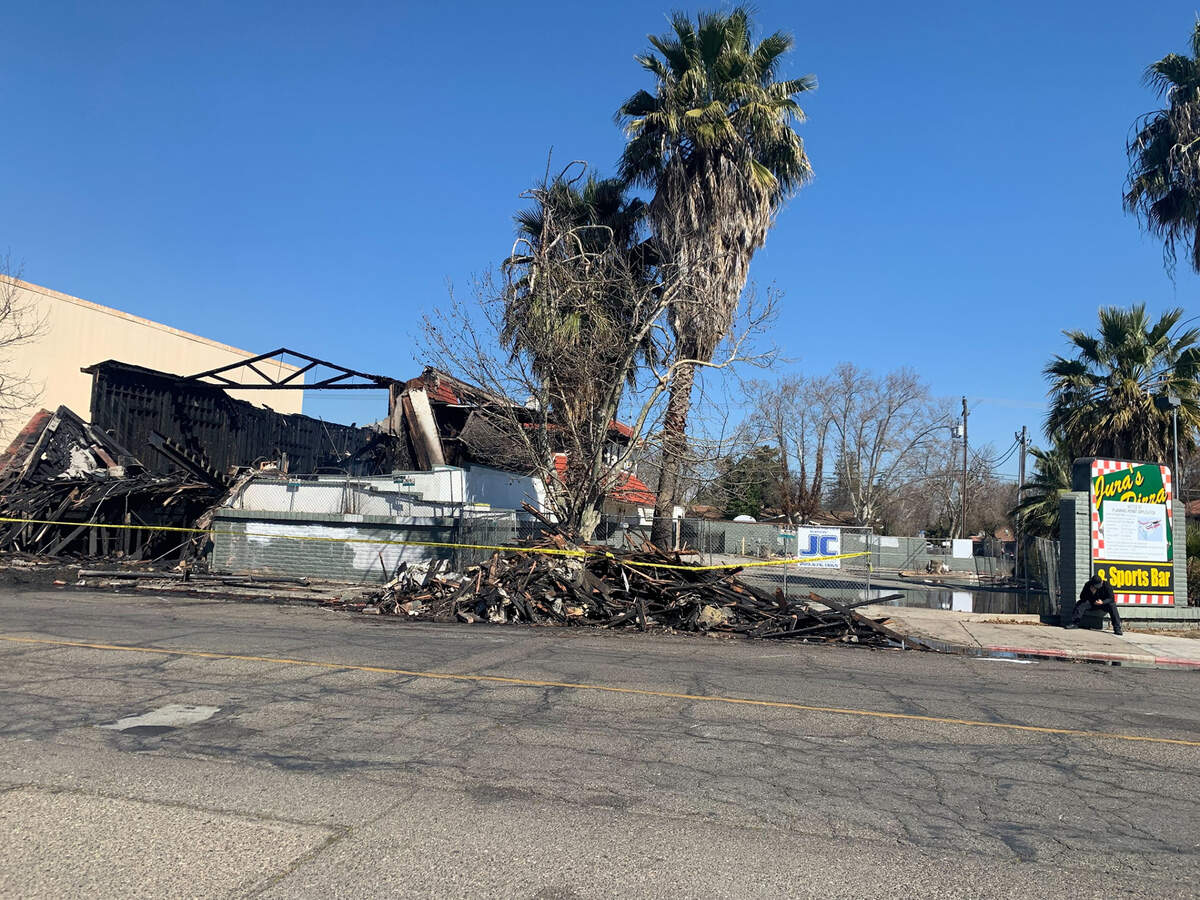 An unoccupied building in the 300 block of North Center Street in Turlock smolders Friday, Feb. 25, 2022, after a fire. Turlock and Stanislaus County fire crews responded to the commercial fire overnight.